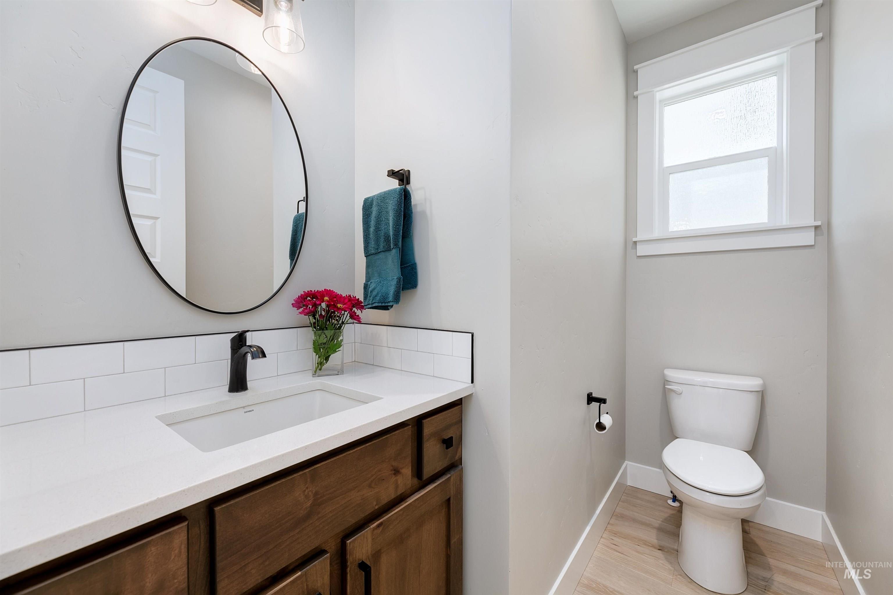 5463 North Exeter Way Meridian, ID 83646 - Photo 20 of 36 Half bath featuring vanity and quartz countertops.