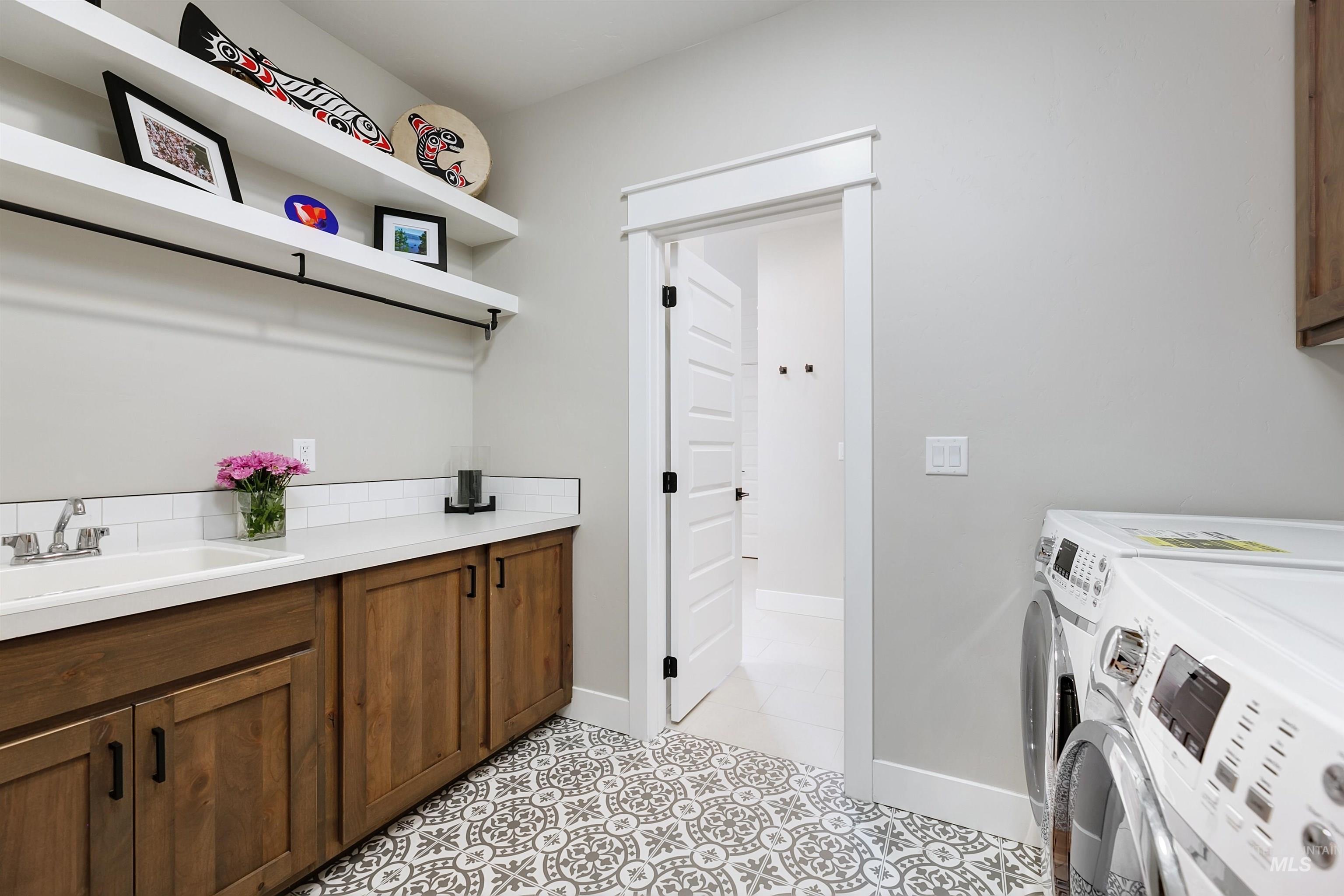 5463 North Exeter Way Meridian, ID 83646 - Photo 21 of 36 Downstairs laundry room conveniently connects to primary en-suite.