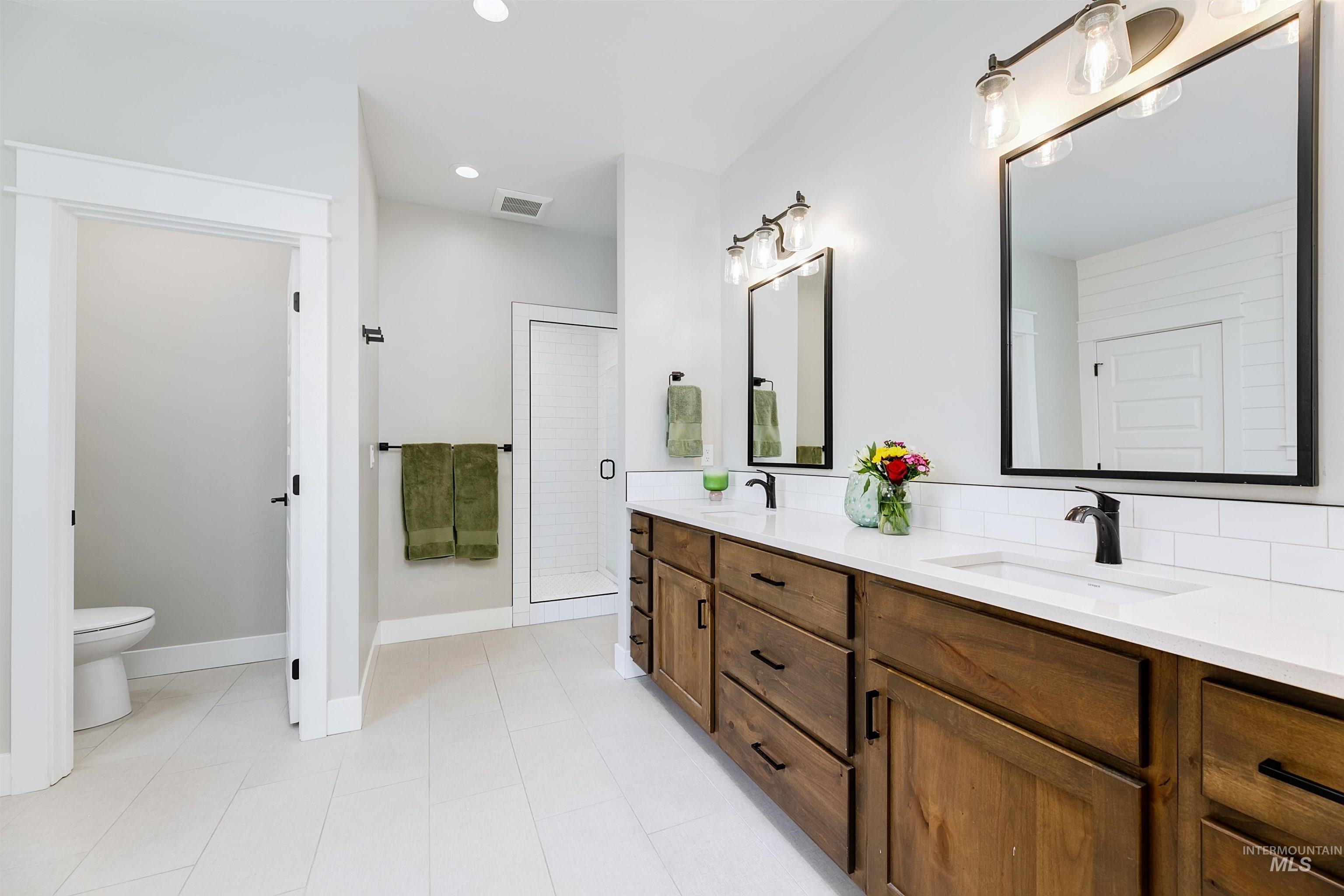 5463 North Exeter Way Meridian, ID 83646 - Photo 9 of 36 Spa like primary bathroom with double vanity, quartz counter tops, free stand bathtub and fully tiled walk-in shower