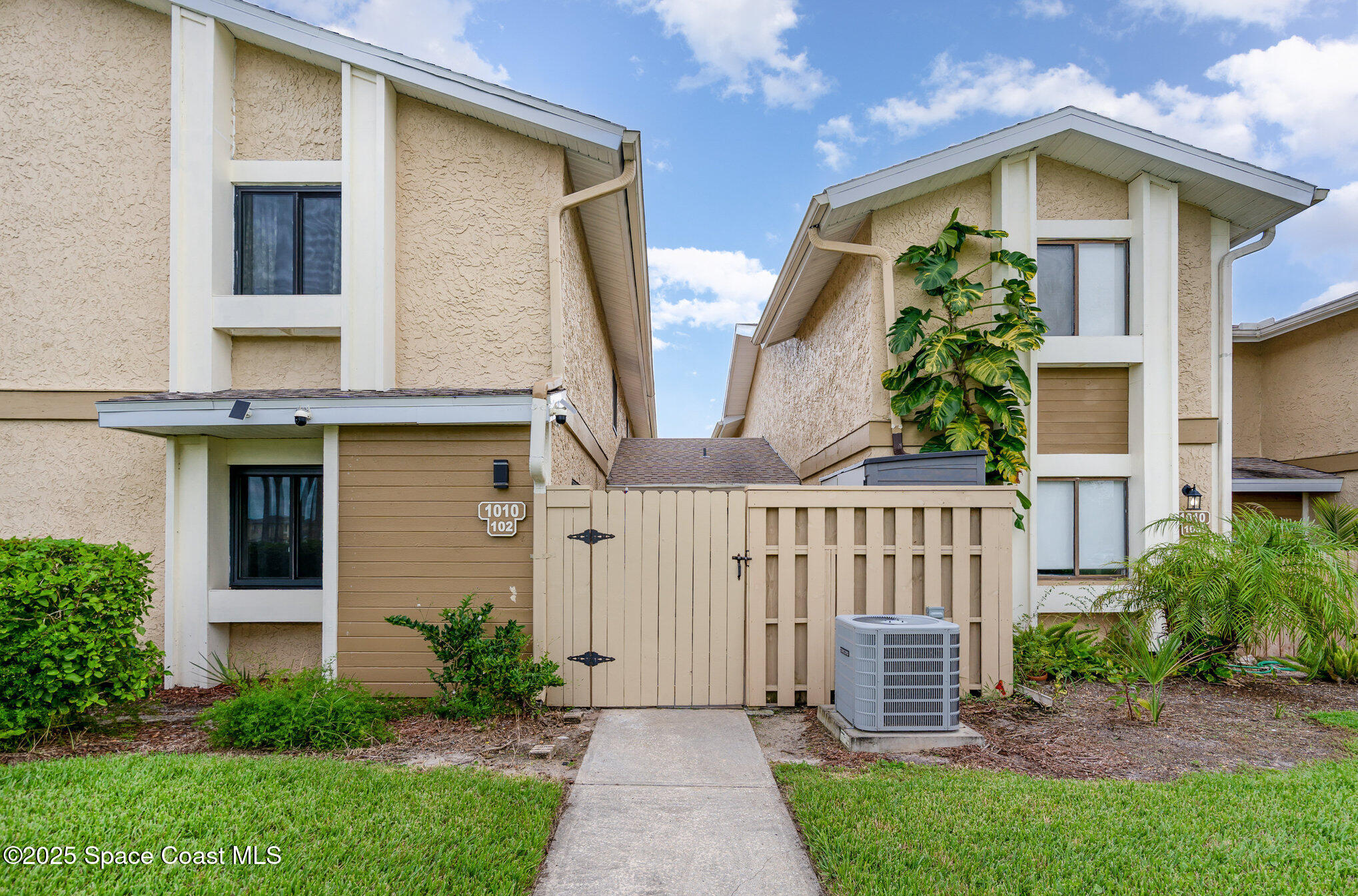 1010 Abada Court Northeast, Unit 102 Palm Bay, FL 32905 - Photo 1 of 37 a front view of house with yard