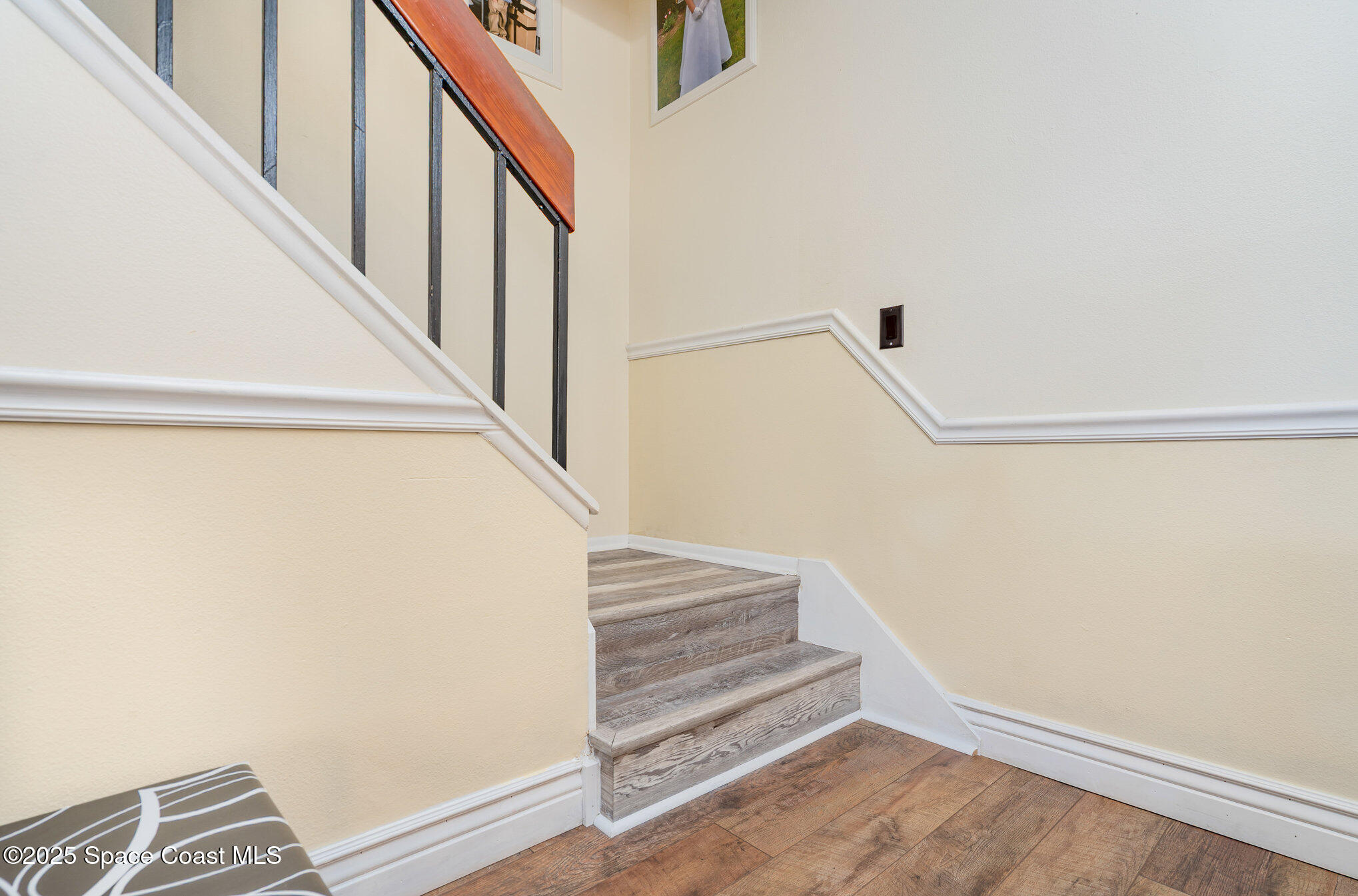 1010 Abada Court Northeast, Unit 102 Palm Bay, FL 32905 - Photo 17 of 37 a view of staircase with wooden floor and white walls