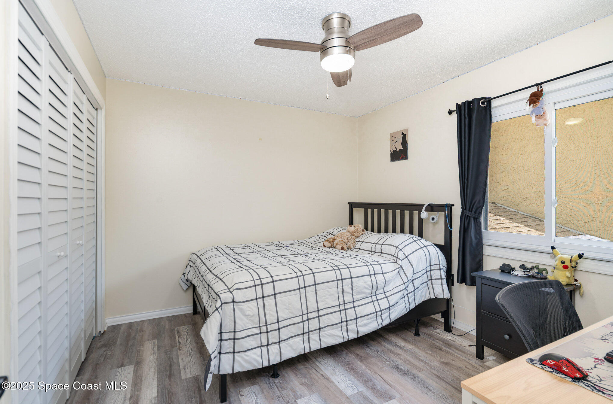 1010 Abada Court Northeast, Unit 102 Palm Bay, FL 32905 - Photo 18 of 37 a bedroom with a bed and wooden floor