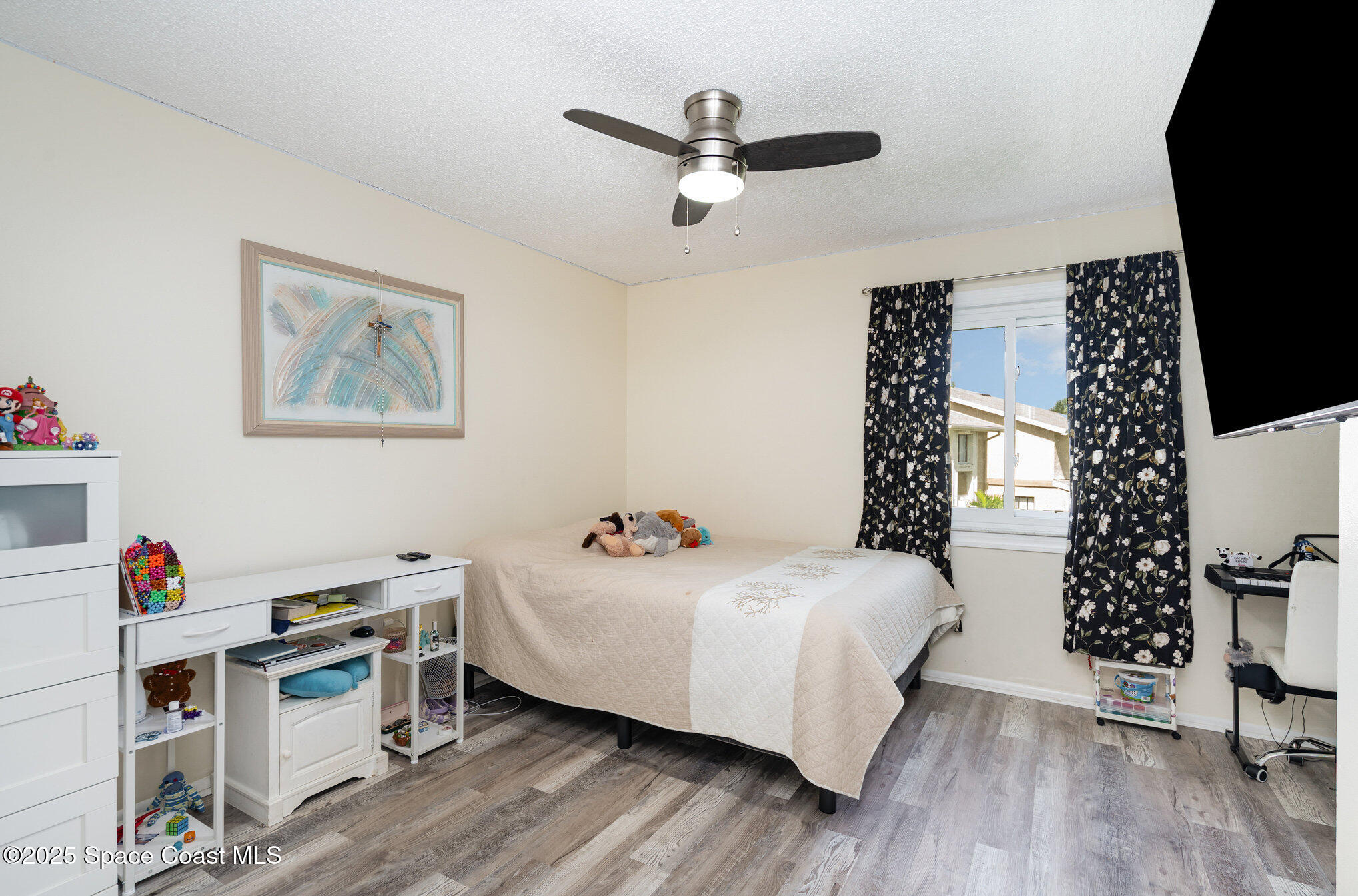 1010 Abada Court Northeast, Unit 102 Palm Bay, FL 32905 - Photo 21 of 37 a bedroom with a bed and a window