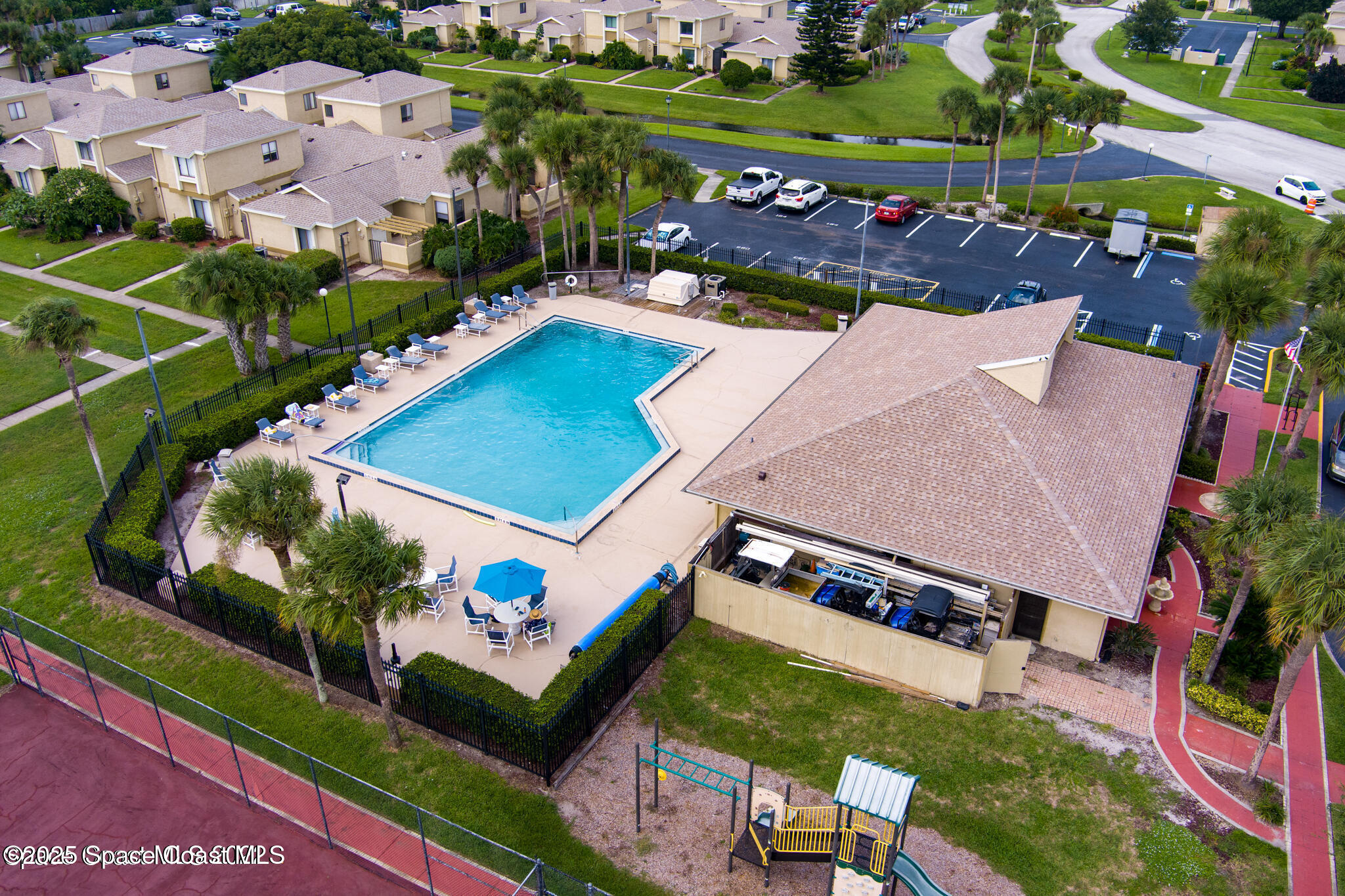 1010 Abada Court Northeast, Unit 102 Palm Bay, FL 32905 - Photo 24 of 37 an aerial view of a tennis ground and a cars park side of the road