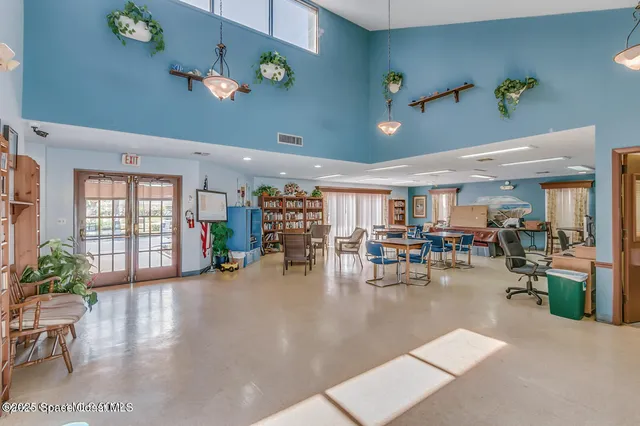 a view of a house with potted plants