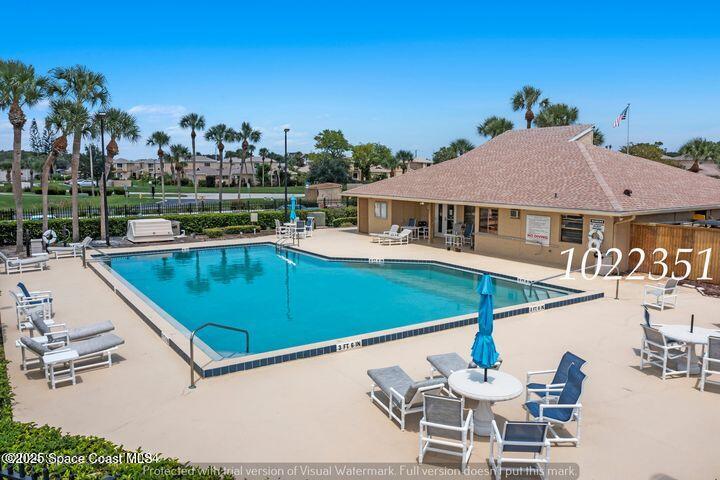 1010 Abada Court Northeast, Unit 102 Palm Bay, FL 32905 - Photo 27 of 37 a view of a patio with swimming pool table and chairs