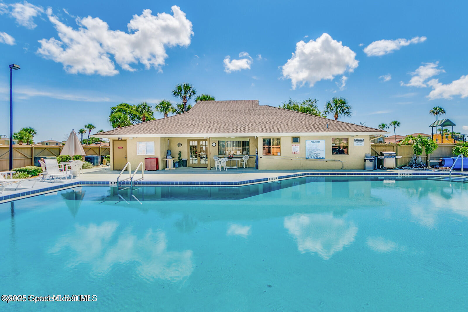 1010 Abada Court Northeast, Unit 102 Palm Bay, FL 32905 - Photo 28 of 37 a view of house with swimming pool outdoor seating