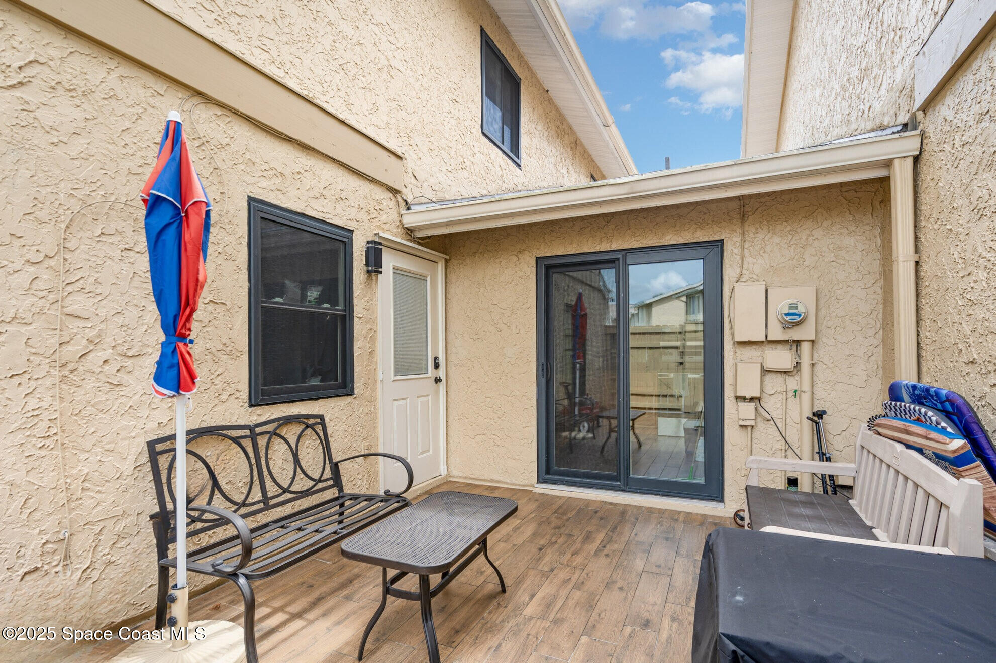 1010 Abada Court Northeast, Unit 102 Palm Bay, FL 32905 - Photo 3 of 37 a front view of a house with outdoor seating