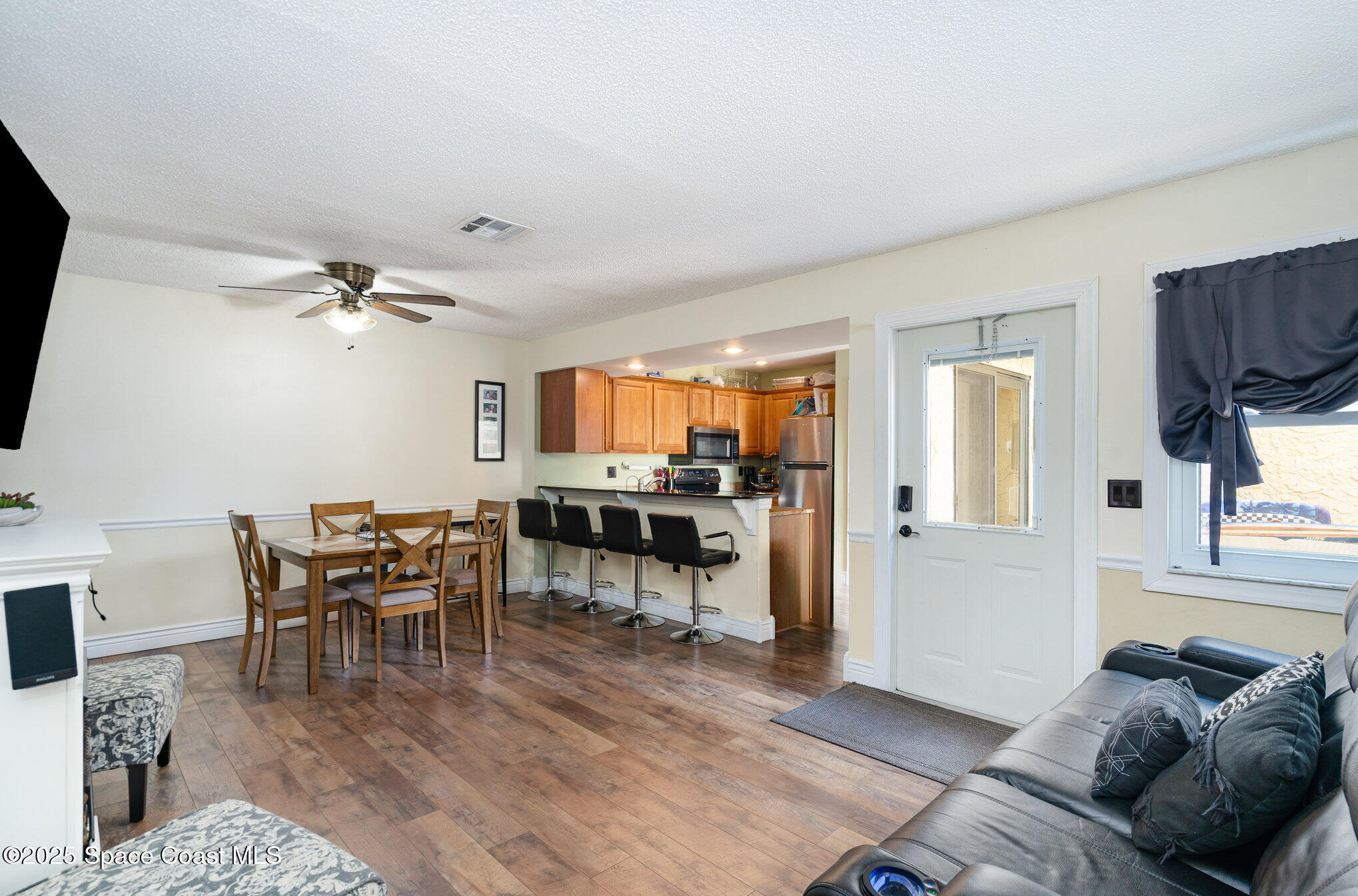 1010 Abada Court Northeast, Unit 102 Palm Bay, FL 32905 - Photo 9 of 37 a living room with furniture and a flat screen tv