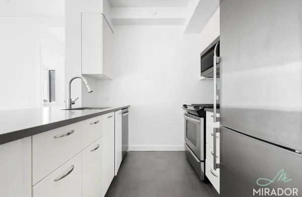 a kitchen with cabinets and a stove