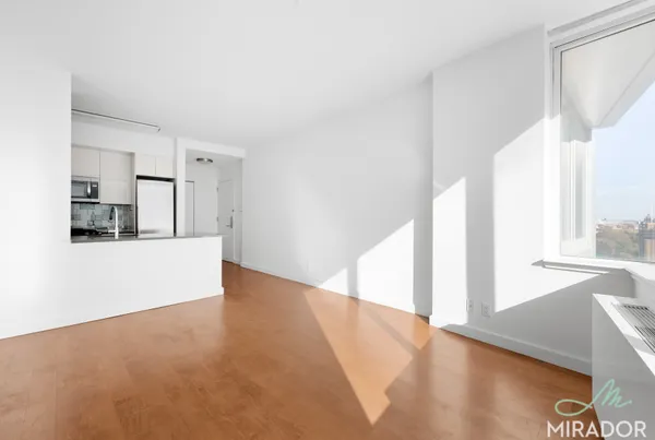 a view of a kitchen with an entryway and refrigerator