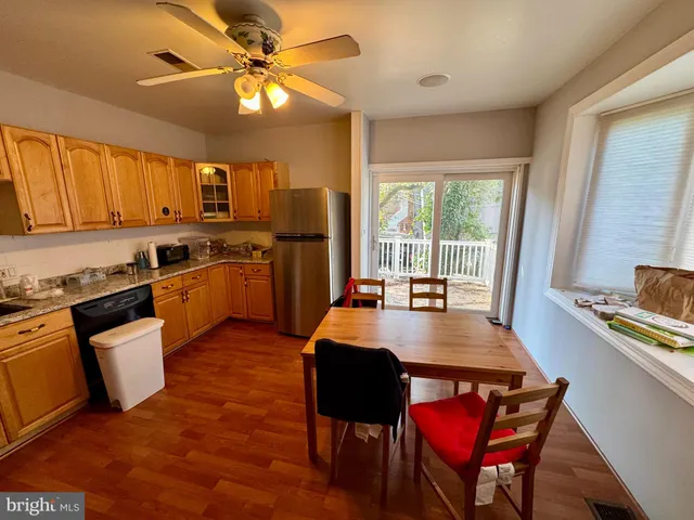a kitchen with stainless steel appliances granite countertop a stove a table and chairs in it