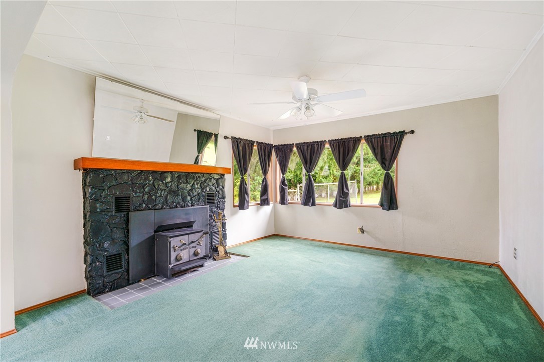 426 Harmon Road Chehalis, WA 98532 - Photo 7 of 31 a view of an empty room with a fireplace and a window