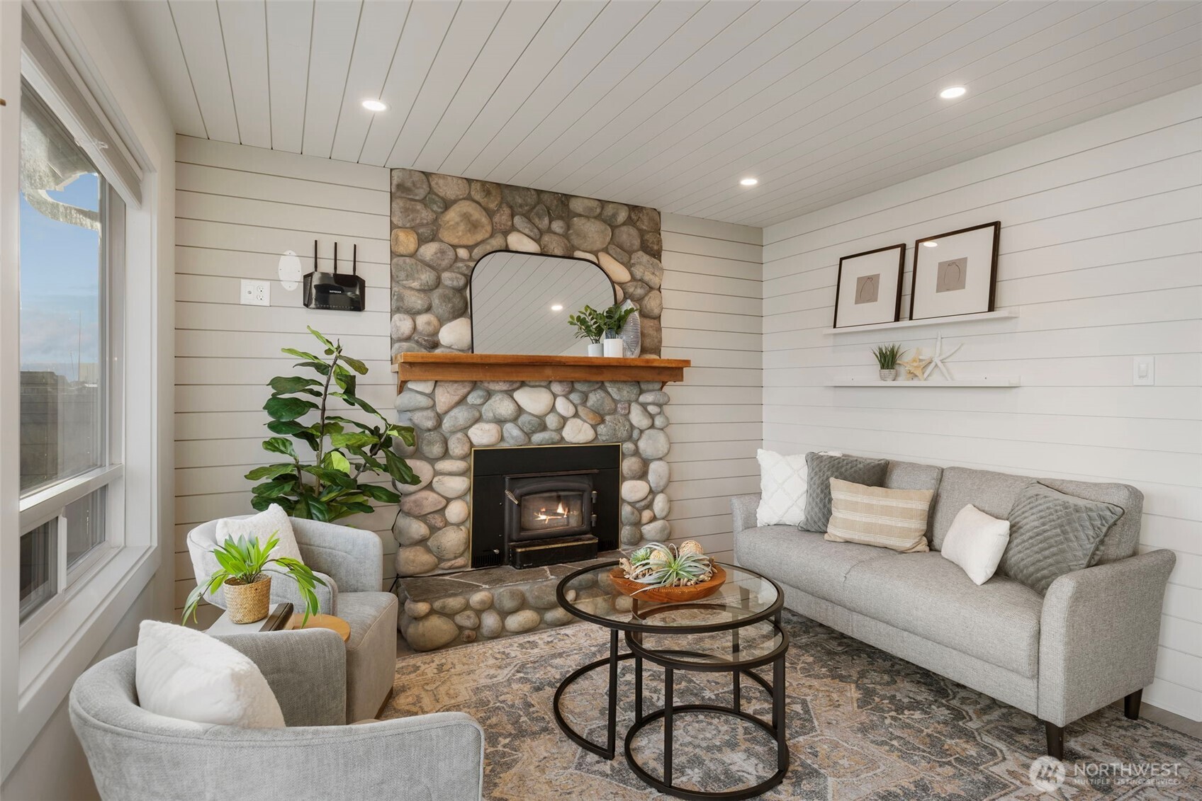 1180 Beckett Point Road Port Townsend, WA 98368 - Photo 11 of 31 a living room with furniture and a fireplace