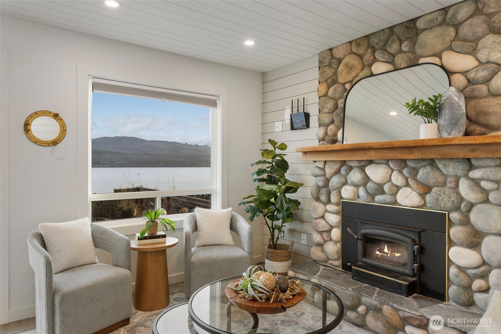 1180 Beckett Point Road Port Townsend, WA 98368 - Photo 12 of 31 a living room with furniture and a fireplace