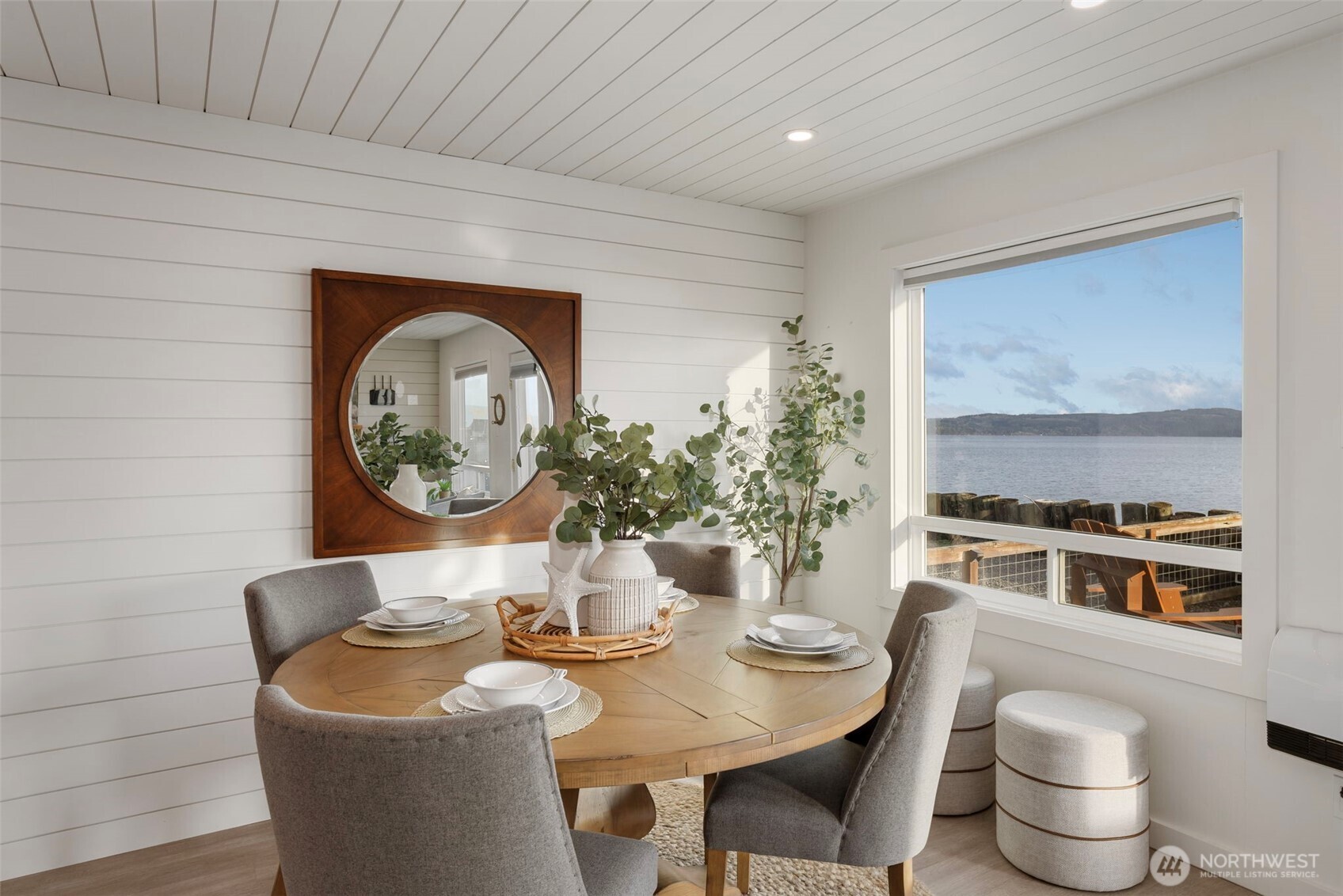 1180 Beckett Point Road Port Townsend, WA 98368 - Photo 14 of 31 a living room with furniture a potted plant and a fireplace
