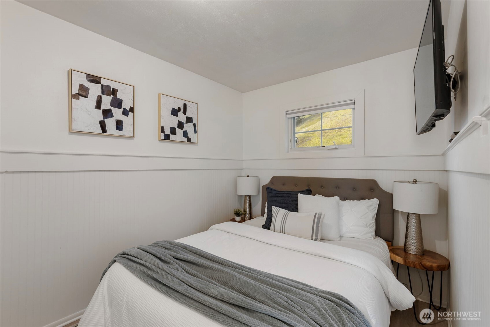 1180 Beckett Point Road Port Townsend, WA 98368 - Photo 21 of 31 a bedroom with a bed and painting on the wall