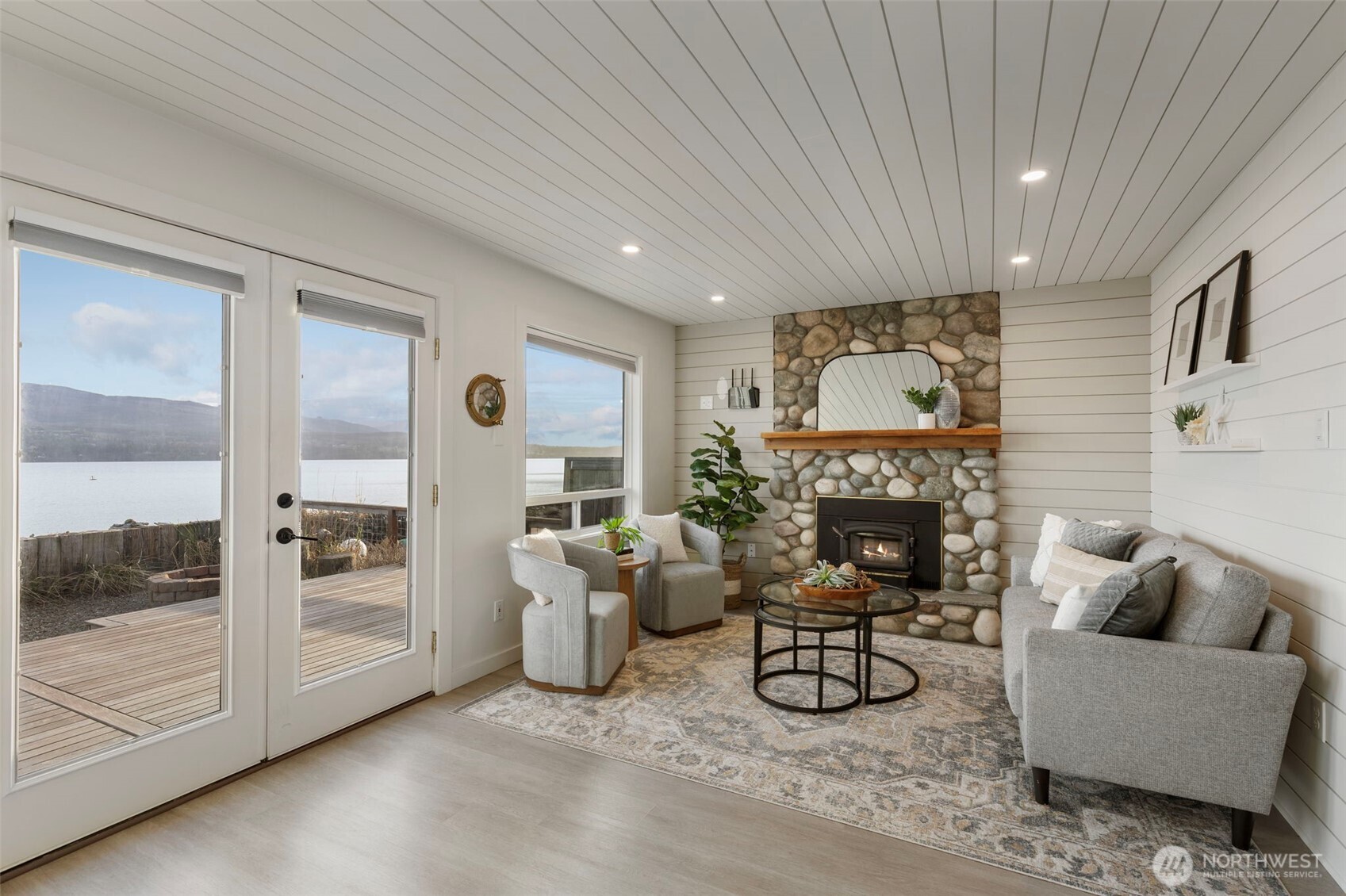 1180 Beckett Point Road Port Townsend, WA 98368 - Photo 10 of 31 a living room with furniture a fireplace and a table