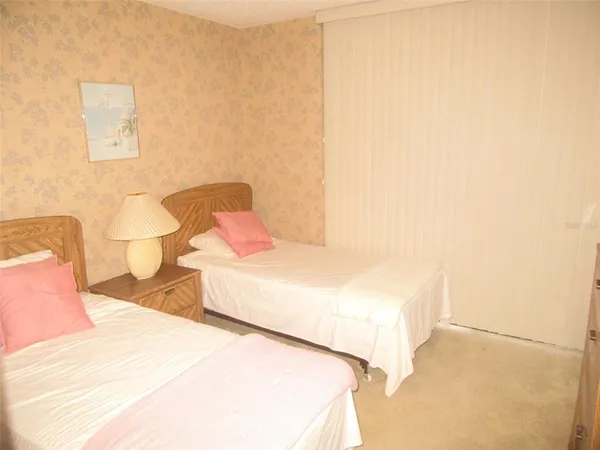 a bedroom with a bed and a potted plant