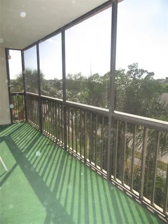 a view of balcony with yard