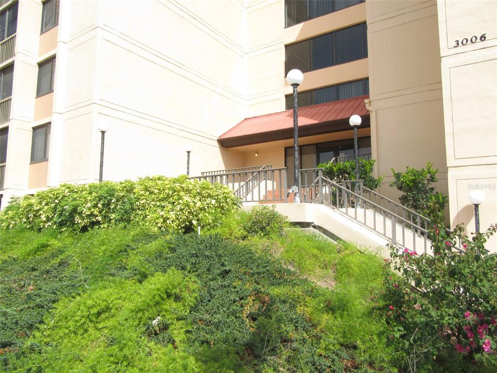 3006 Caring Way, Unit 422 Port Charlotte, FL 33952 - Photo 2 of 14 a view of a house with a small yard and plants