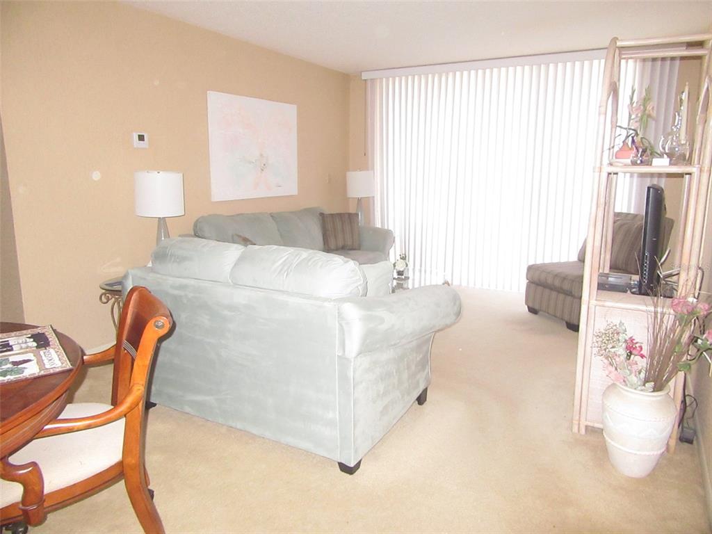 3006 Caring Way, Unit 422 Port Charlotte, FL 33952 - Photo 3 of 14 a living room with furniture and a large window