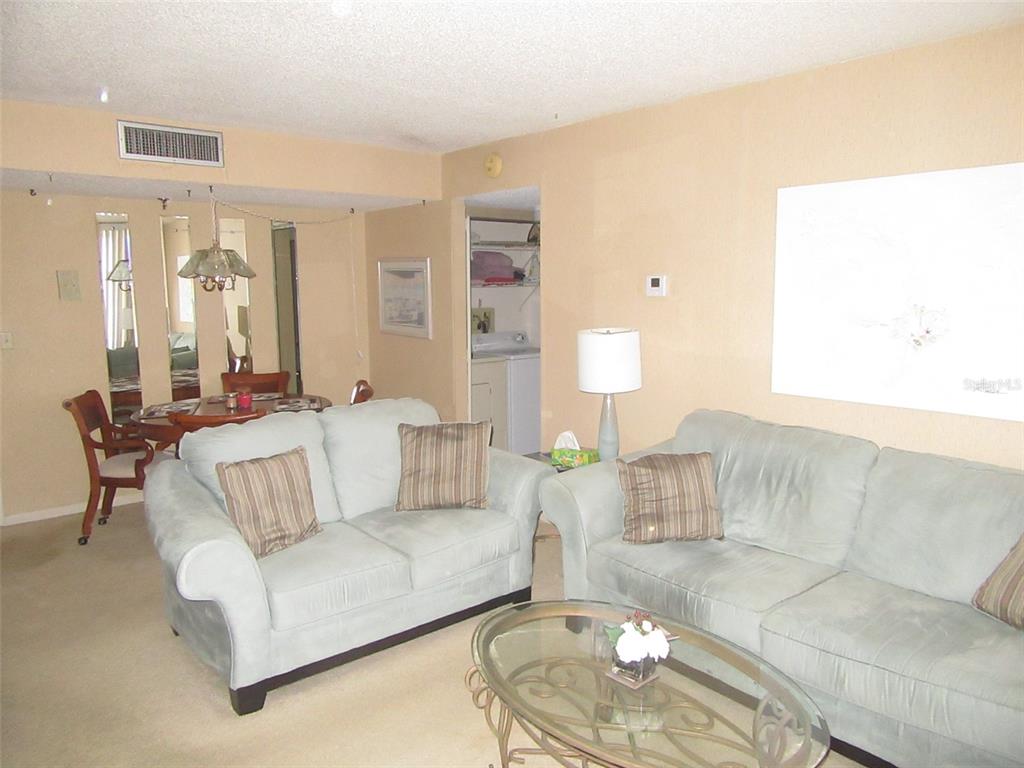 3006 Caring Way, Unit 422 Port Charlotte, FL 33952 - Photo 4 of 14 a living room with furniture and a couch