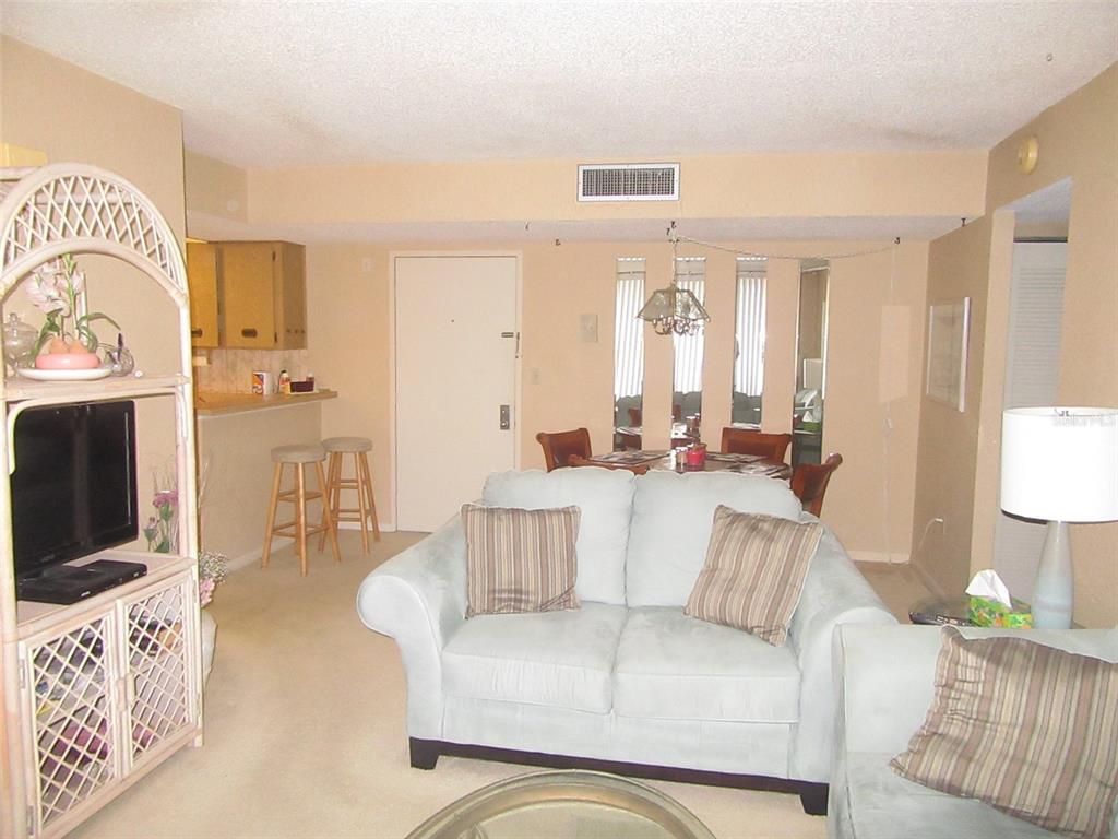 3006 Caring Way, Unit 422 Port Charlotte, FL 33952 - Photo 5 of 14 a living room with furniture and a flat screen tv