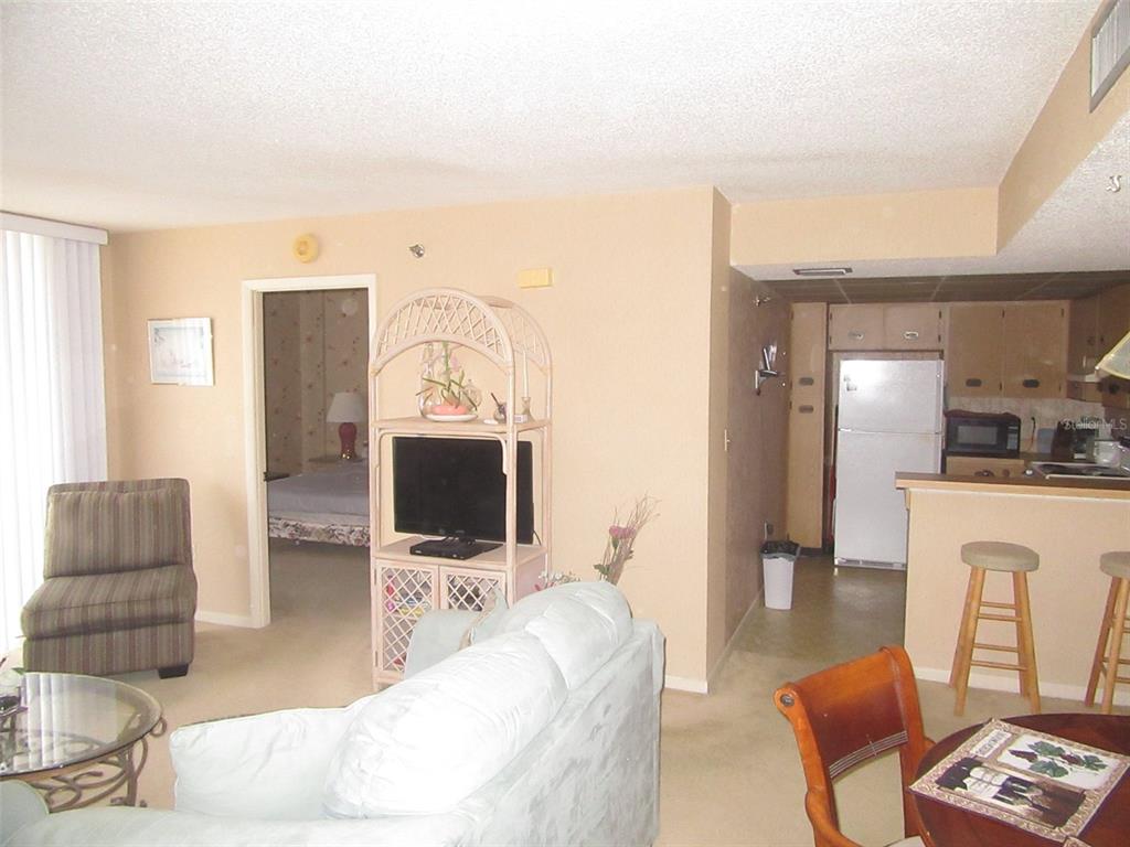 3006 Caring Way, Unit 422 Port Charlotte, FL 33952 - Photo 6 of 14 a living room with furniture and a flat screen tv
