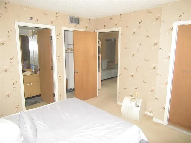 a bedroom with a bed and a bathroom