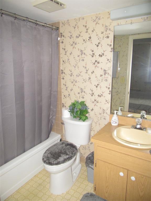 3006 Caring Way, Unit 422 Port Charlotte, FL 33952 - Photo 10 of 14 a bathroom with a sink a toilet and a mirror
