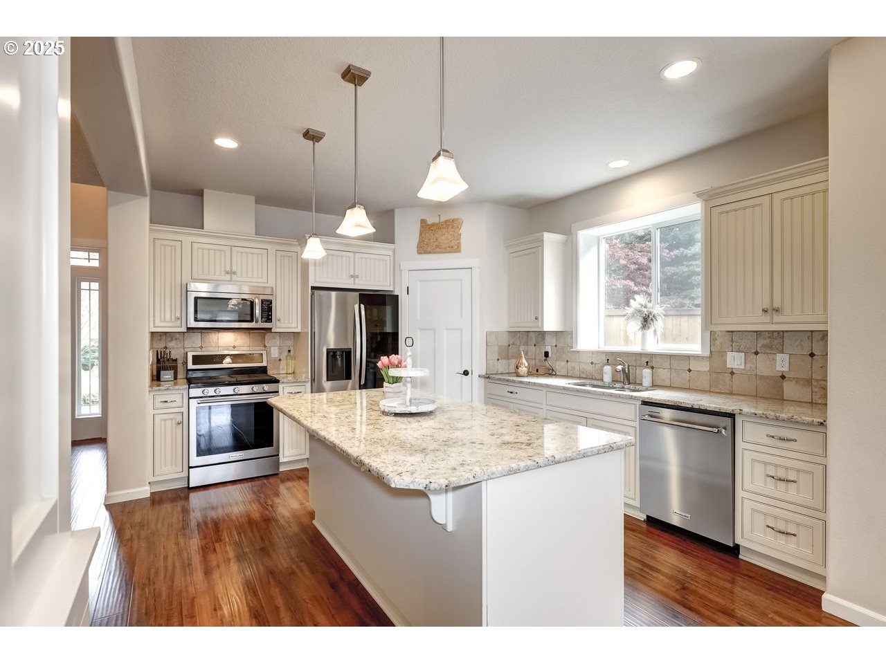 17647 Hardenbrook Avenue Sandy, OR 97055 - Photo 13 of 39 a kitchen with a center island wooden floor and stainless steel appliances