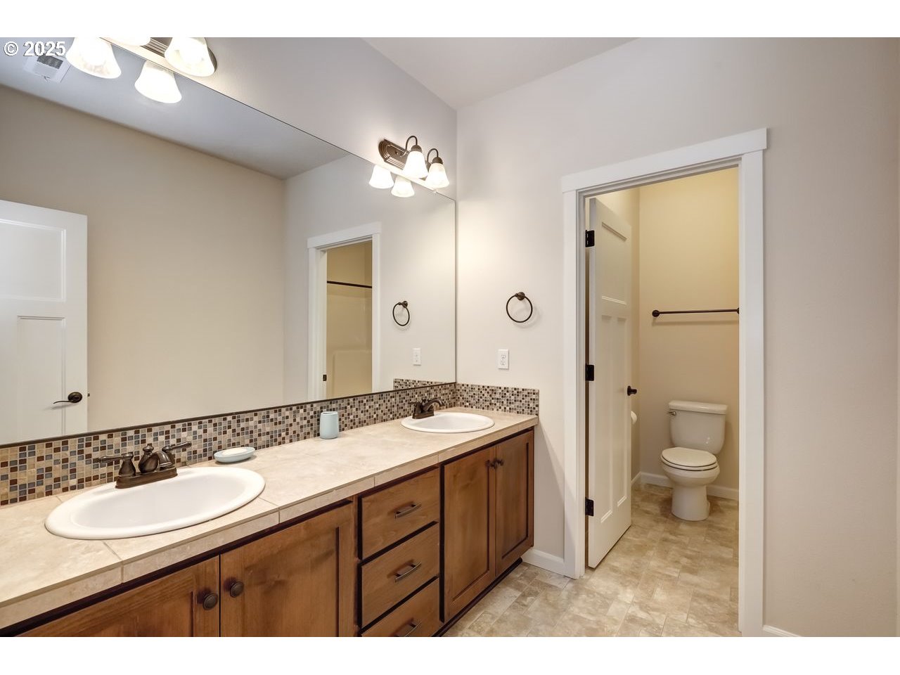 17647 Hardenbrook Avenue Sandy, OR 97055 - Photo 30 of 39 a bathroom with a granite countertop double vanity sink a mirror and a toilet