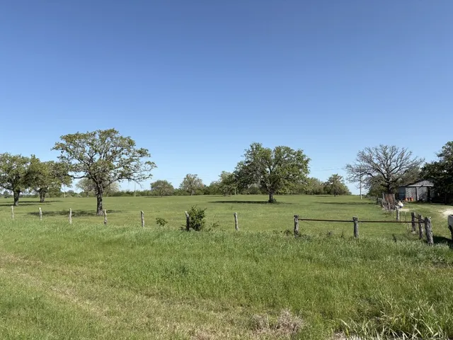 a view of outdoor space with green field and trees