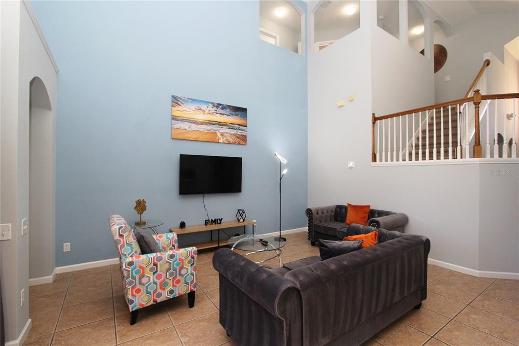 8211 Fan Palm Way Kissimmee, FL 34747 - Photo 11 of 41 a bedroom with bed and a flat screen tv