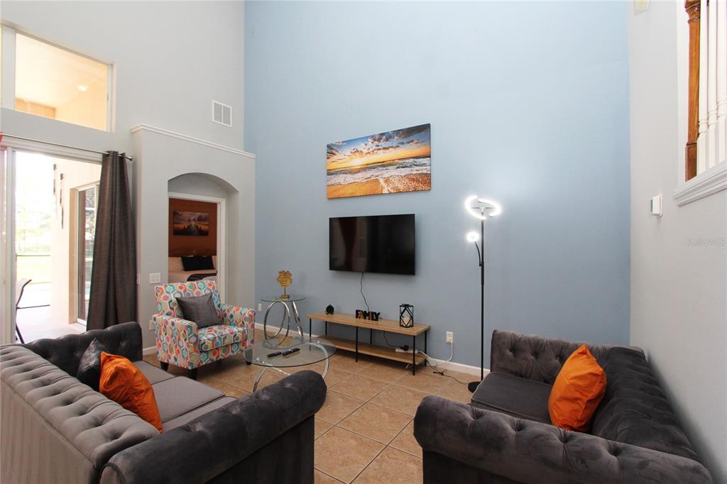 8211 Fan Palm Way Kissimmee, FL 34747 - Photo 15 of 41 a living room with furniture and a flat screen tv