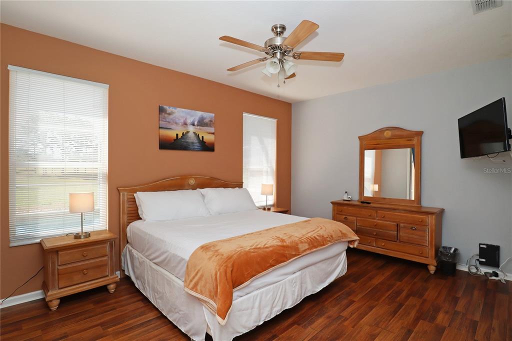 8211 Fan Palm Way Kissimmee, FL 34747 - Photo 16 of 41 a bedroom with a bed wooden floor and window