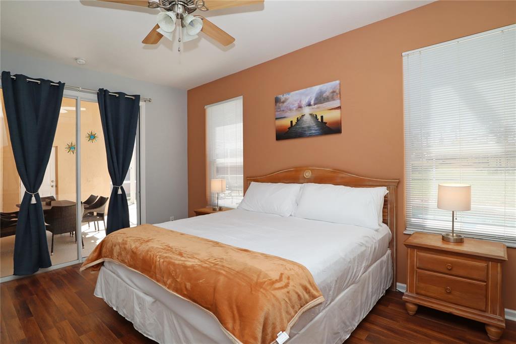 8211 Fan Palm Way Kissimmee, FL 34747 - Photo 18 of 41 a bedroom with a bed and a chandelier