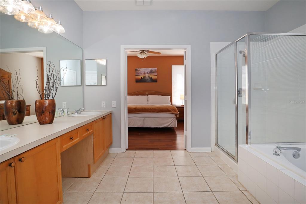 8211 Fan Palm Way Kissimmee, FL 34747 - Photo 19 of 41 a en suite bathroom with a tub shower and sink