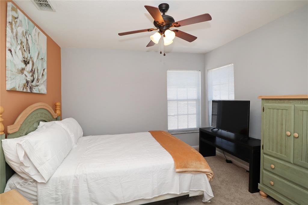 8211 Fan Palm Way Kissimmee, FL 34747 - Photo 24 of 41 a bedroom with a bed and a flat screen tv