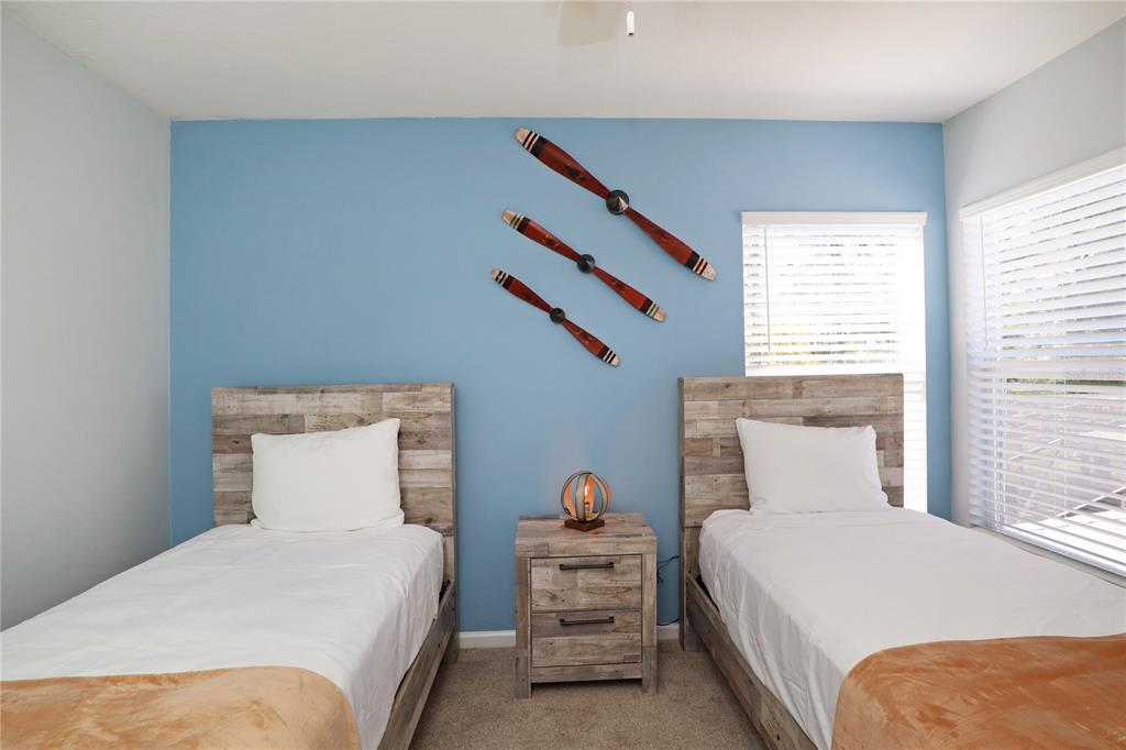 8211 Fan Palm Way Kissimmee, FL 34747 - Photo 25 of 41 a bedroom with a bed and window