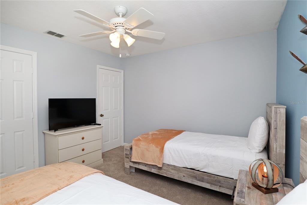 8211 Fan Palm Way Kissimmee, FL 34747 - Photo 26 of 41 a bedroom with a bed and a flat screen tv