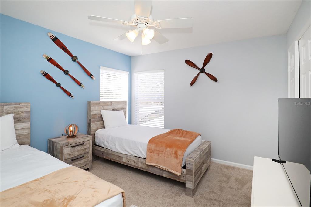8211 Fan Palm Way Kissimmee, FL 34747 - Photo 27 of 41 a bedroom with a bed a window and a chandelier