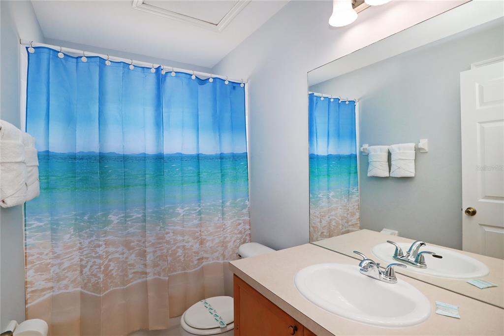 8211 Fan Palm Way Kissimmee, FL 34747 - Photo 28 of 41 a bathroom with a sink a toilet and shower