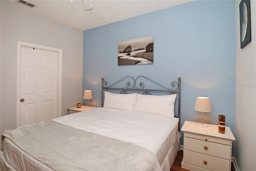 8211 Fan Palm Way Kissimmee, FL 34747 - Photo 29 of 41 a bedroom with a bed and a lamp on dresser