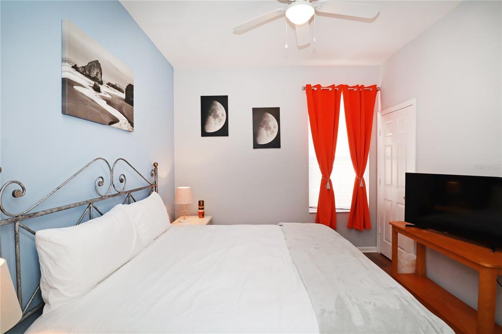 8211 Fan Palm Way Kissimmee, FL 34747 - Photo 30 of 41 a bedroom with a bed and a flat screen tv