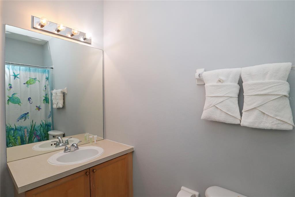 8211 Fan Palm Way Kissimmee, FL 34747 - Photo 40 of 41 a bathroom with a sink vanity and a mirror