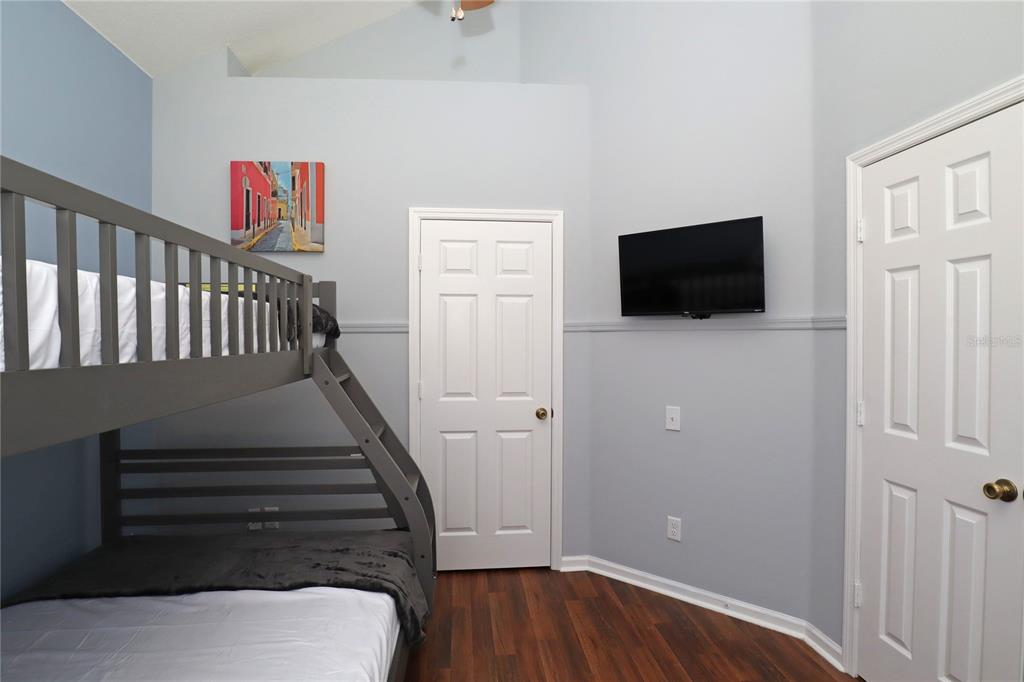 8211 Fan Palm Way Kissimmee, FL 34747 - Photo 4 of 41 a view of a livingroom with wooden floor and a flat screen tv