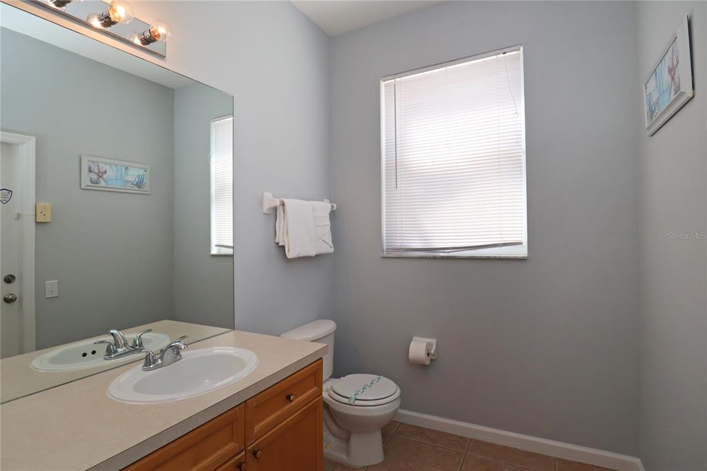 8211 Fan Palm Way Kissimmee, FL 34747 - Photo 10 of 41 a bathroom with a sink a toilet and a mirror