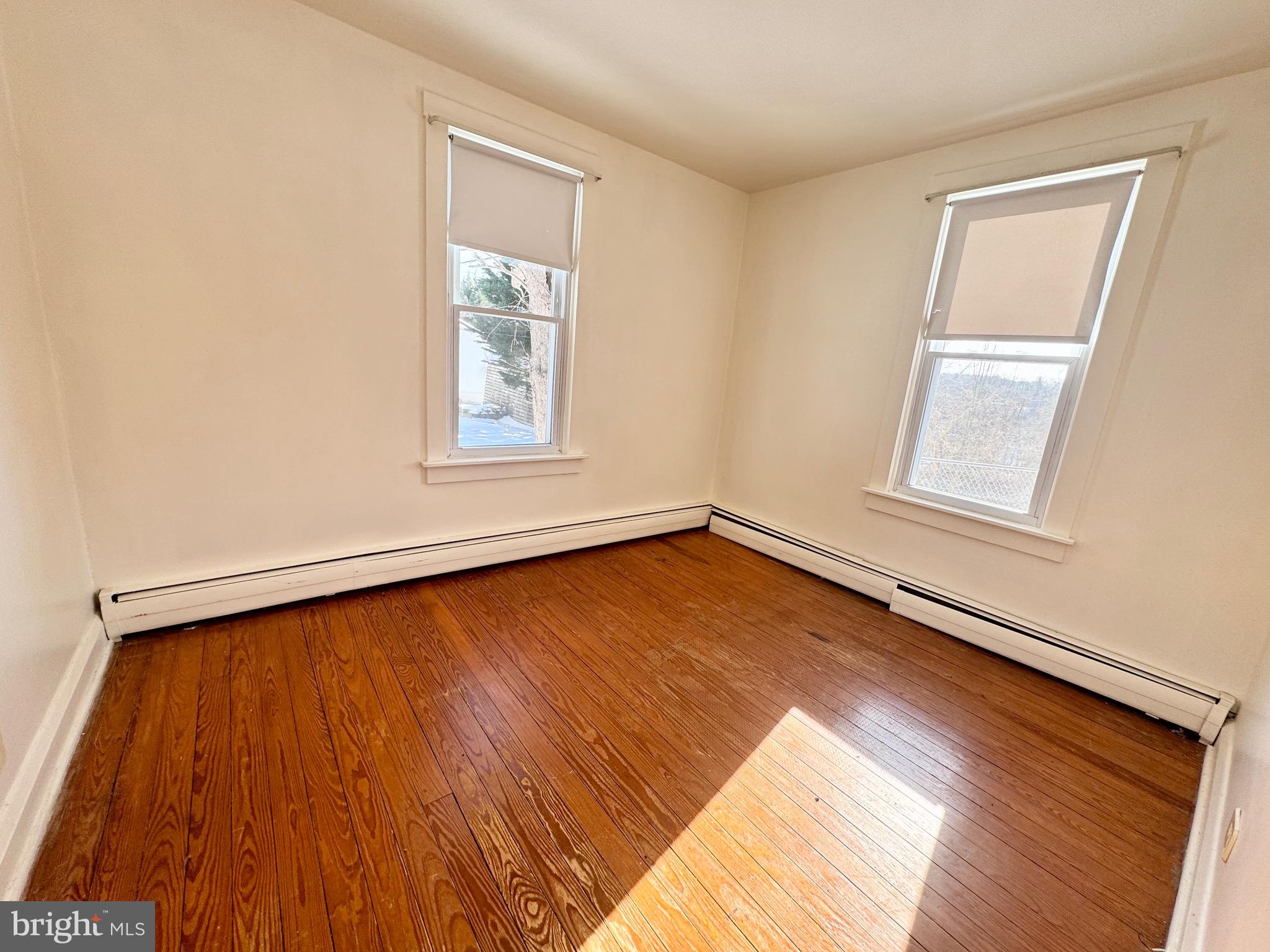 2847 Baltimore Boulevard, Unit B Finksburg, MD 21048 - Photo 19 of 25 an empty room with wooden floor and windows